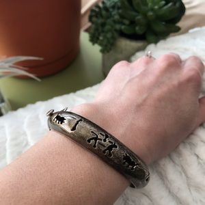 Silver bangle bracelet with tribal cut outs